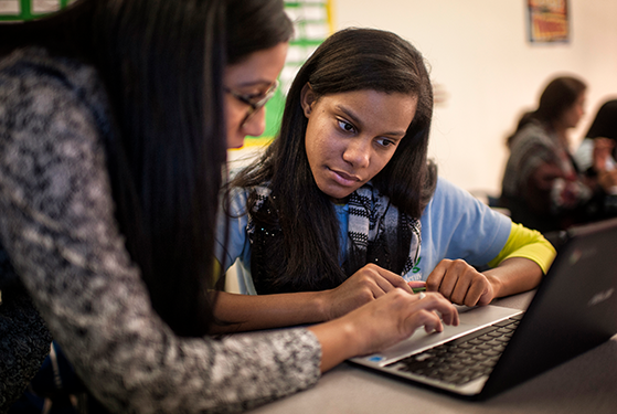 Teacher giving student personalized writing support and feedback